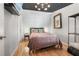 Cozy bedroom with a comfortable bed, stylish lighting, and tasteful decor with hardwood floors at 943 Peachtree Ne St # 1603, Atlanta, GA 30309