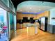 Stylish kitchen featuring stainless steel appliances, an island with bar seating, and a door to the balcony at 943 Peachtree Ne St # 1603, Atlanta, GA 30309