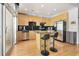 Modern kitchen with stainless steel appliances, black tile backsplash, an island, and access to a private balcony at 943 Peachtree Ne St # 1603, Atlanta, GA 30309