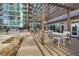 Outdoor patio featuring dining tables with outdoor kitchen and community amenities at 943 Peachtree Ne St # 1603, Atlanta, GA 30309