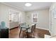 Bright dining area featuring a glass table, modern chairs, and hardwood flooring at 1013 Columbia Dr, Decatur, GA 30030