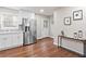 Bright kitchen featuring stainless steel refrigerator, white cabinets, and luxury vinyl plank flooring at 1013 Columbia Dr, Decatur, GA 30030