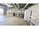 Spacious unfinished basement with exposed ceiling, mini-bar and white-painted walls at 187 Bowden Rd, Ellenwood, GA 30294
