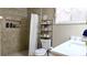 Bathroom featuring a toilet, shelving, vanity, and decorative shower at 187 Bowden Rd, Ellenwood, GA 30294