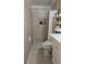 Bathroom featuring a shower, toilet, shelving, and tile at 187 Bowden Rd, Ellenwood, GA 30294