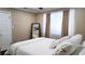 Bedroom with a large framed mirror and large bed with white linens by a window at 187 Bowden Rd, Ellenwood, GA 30294