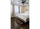 Cozy bedroom featuring hardwood floors, ceiling fan, and natural light from the window at 187 Bowden Rd, Ellenwood, GA 30294