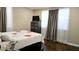 Bedroom with hardwood floors, dresser, and bright natural light from the windows at 187 Bowden Rd, Ellenwood, GA 30294