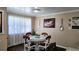 Inviting dining room with a glass top table, seating for four, and bright natural light at 187 Bowden Rd, Ellenwood, GA 30294