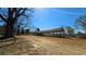 Scenic view of a single-story home with an extensive covered patio, surrounded by mature trees and open space at 187 Bowden Rd, Ellenwood, GA 30294