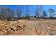 Wide open view of a property under construction, including a covered structure and a glimpse of the home at 187 Bowden Rd, Ellenwood, GA 30294