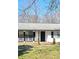 Welcoming front porch with seating and 'welcome' sign, offering a charming entry to the home at 187 Bowden Rd, Ellenwood, GA 30294