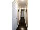 Hallway with dark wood floors, neutral walls and white doors offer inviting transitional space at 187 Bowden Rd, Ellenwood, GA 30294