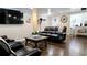 Comfortable living room with dark leather furniture, hardwood floors, and bright natural light at 187 Bowden Rd, Ellenwood, GA 30294