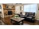 Cozy living room with a stone fireplace, leather seating, and hardwood floors at 187 Bowden Rd, Ellenwood, GA 30294