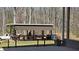 Outdoor kitchen features covered seating area, grill, and wooded surround at 187 Bowden Rd, Ellenwood, GA 30294