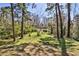 A spacious, grassy backyard surrounded by mature trees, providing shade and privacy at 1949 Capri Dr, Decatur, GA 30032