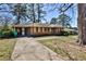 Charming single story brick house with a covered parking, driveway, and front yard at 1949 Capri Dr, Decatur, GA 30032