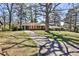 Charming single-story home with a long driveway and lush front lawn shaded by mature trees at 1949 Capri Dr, Decatur, GA 30032
