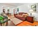 Cozy living room featuring hardwood floors, a sofa, and an adjacent dining area at 1949 Capri Dr, Decatur, GA 30032