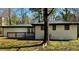 Back exterior view of the home with a lovely yard and a deck at 2403 Dawn Dr, Decatur, GA 30032