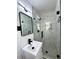 Modern bathroom featuring white marble tile, a glass shower door, and matte black fixtures at 2403 Dawn Dr, Decatur, GA 30032