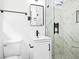 Modern bathroom featuring a glass-enclosed shower with marble tile and a sleek vanity at 2403 Dawn Dr, Decatur, GA 30032