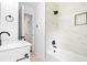 Modern bathroom with marble countertop vanity, and black shower with built in niche at 2403 Dawn Dr, Decatur, GA 30032