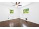 Bright bedroom featuring hardwood floors, a ceiling fan, and natural light from windows at 2403 Dawn Dr, Decatur, GA 30032