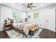 Well-decorated bedroom features hardwood floors, plush bed, and ample natural light at 2403 Dawn Dr, Decatur, GA 30032