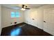 Bedroom with dark hardwood floors, ceiling fan, and bright natural light at 2403 Dawn Dr, Decatur, GA 30032