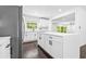Renovated kitchen showcasing a central island with storage, white cabinets, and stainless steel refrigerator at 2403 Dawn Dr, Decatur, GA 30032