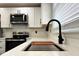 Updated kitchen featuring white countertops and cabinets, stainless appliances, and black hardware at 2403 Dawn Dr, Decatur, GA 30032