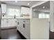 Kitchen with white cabinets, countertops, and island with black hardware at 2403 Dawn Dr, Decatur, GA 30032