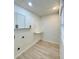 The laundry room features white cabinets, light-colored floors and a small folding table at 2403 Dawn Dr, Decatur, GA 30032