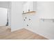 Bright laundry room with white cabinets and laminate wood floors at 2403 Dawn Dr, Decatur, GA 30032