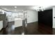 The open concept living room and kitchen shows white cabinets, dark wood floors and a modern design at 2403 Dawn Dr, Decatur, GA 30032
