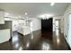 Open-concept kitchen and living room with white cabinets, dark wood floors, and recessed lighting at 2403 Dawn Dr, Decatur, GA 30032