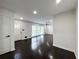 Spacious living room featuring dark wood floors, a ceiling fan, and bright, natural light at 2403 Dawn Dr, Decatur, GA 30032