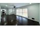Spacious living room featuring gleaming wood floors, large windows with bright, natural light, and a ceiling fan at 2403 Dawn Dr, Decatur, GA 30032