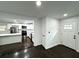 Open-concept living room, featuring views of the kitchen, wood floors, and front door at 2403 Dawn Dr, Decatur, GA 30032