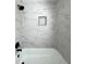 Shower featuring gray marble tiling and black hardware at 2403 Dawn Dr, Decatur, GA 30032