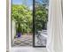 View of a cozy balcony with outdoor seating, patterned rug, and lush green trees in the background at 300 Johnson Ferry Ne Rd # A313, Atlanta, GA 30328