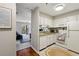 Well-lit kitchen with white cabinetry, modern appliances, and a view into a living area at 300 Johnson Ferry Ne Rd # A313, Atlanta, GA 30328