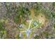 Aerial view of neighborhood homes, showing tree coverage, cul-de-sac, and backyard pond at 370 Burton Dr, Douglasville, GA 30134