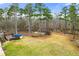 Expansive backyard with a small pond, wooden deck, and above-ground pool at 370 Burton Dr, Douglasville, GA 30134