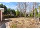 A spacious backyard featuring mature trees and a walkway along the side of the house at 1421 Downs Sw Dr, Atlanta, GA 30311