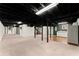 Large basement with painted ceiling, multiple support columns, and a small kitchenette at 1421 Downs Sw Dr, Atlanta, GA 30311