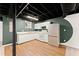 Basement kitchenette featuring white cabinets, stainless fridge, and sleek countertops at 1421 Downs Sw Dr, Atlanta, GA 30311
