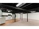 Spacious basement includes a kitchenette with white appliances and ample storage at 1421 Downs Sw Dr, Atlanta, GA 30311